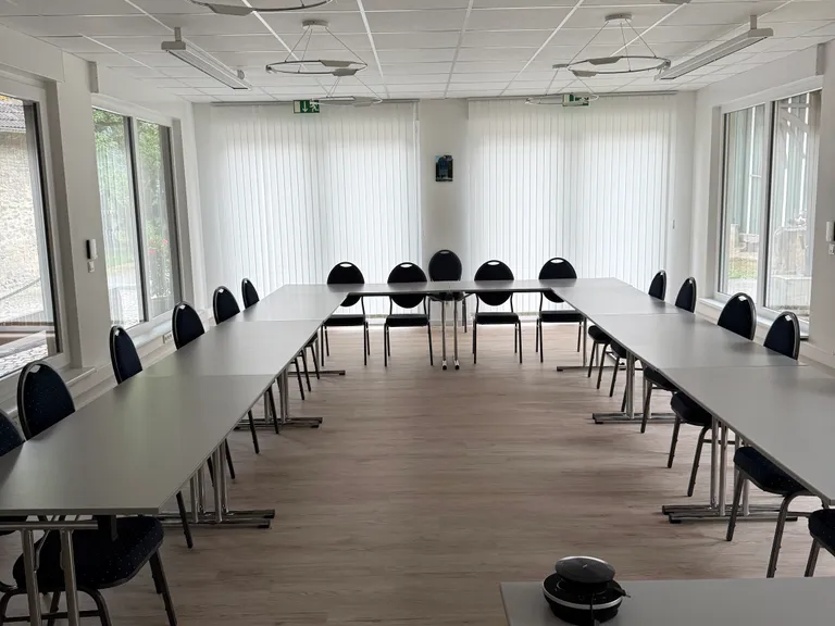 Moderner Seminarraum mit U-förmiger Bestuhlung und Tageslicht
